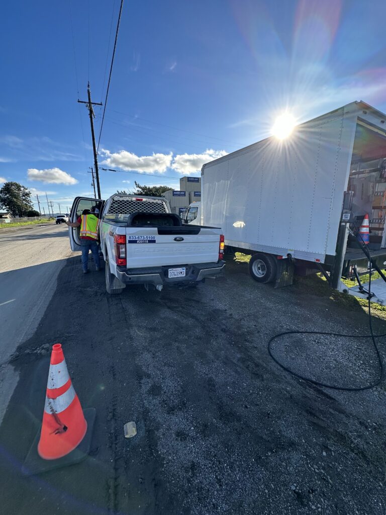 ADM Auto Services mobile repair truck servicing a box truck at the roadside