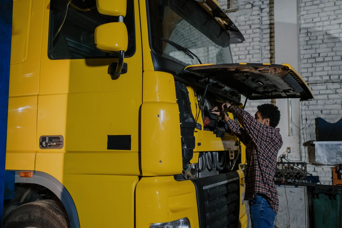 Mechanic working on a commercial truck engine during a repair